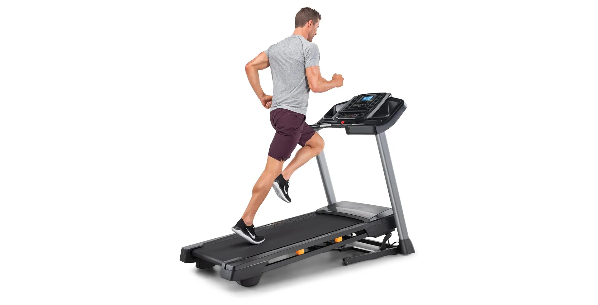 Man running on a NordicTrack T Series 6.5S treadmill with smart display — home fitness cardio equipment with incline and iFIT compatibility.