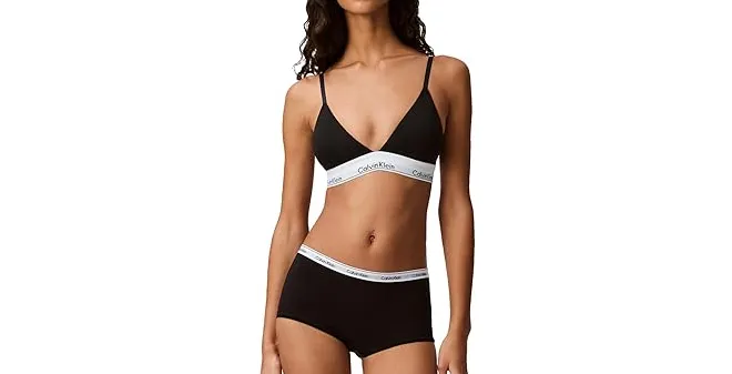 Model wearing black Calvin Klein Triangle Wireless Bralette and matching hipster underwear with signature white logo band – minimal, comfortable lingerie set for everyday wear.